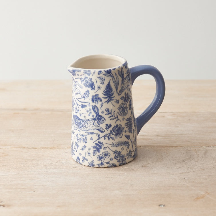 PIchet bleu avec motifs de fleurs et lapin